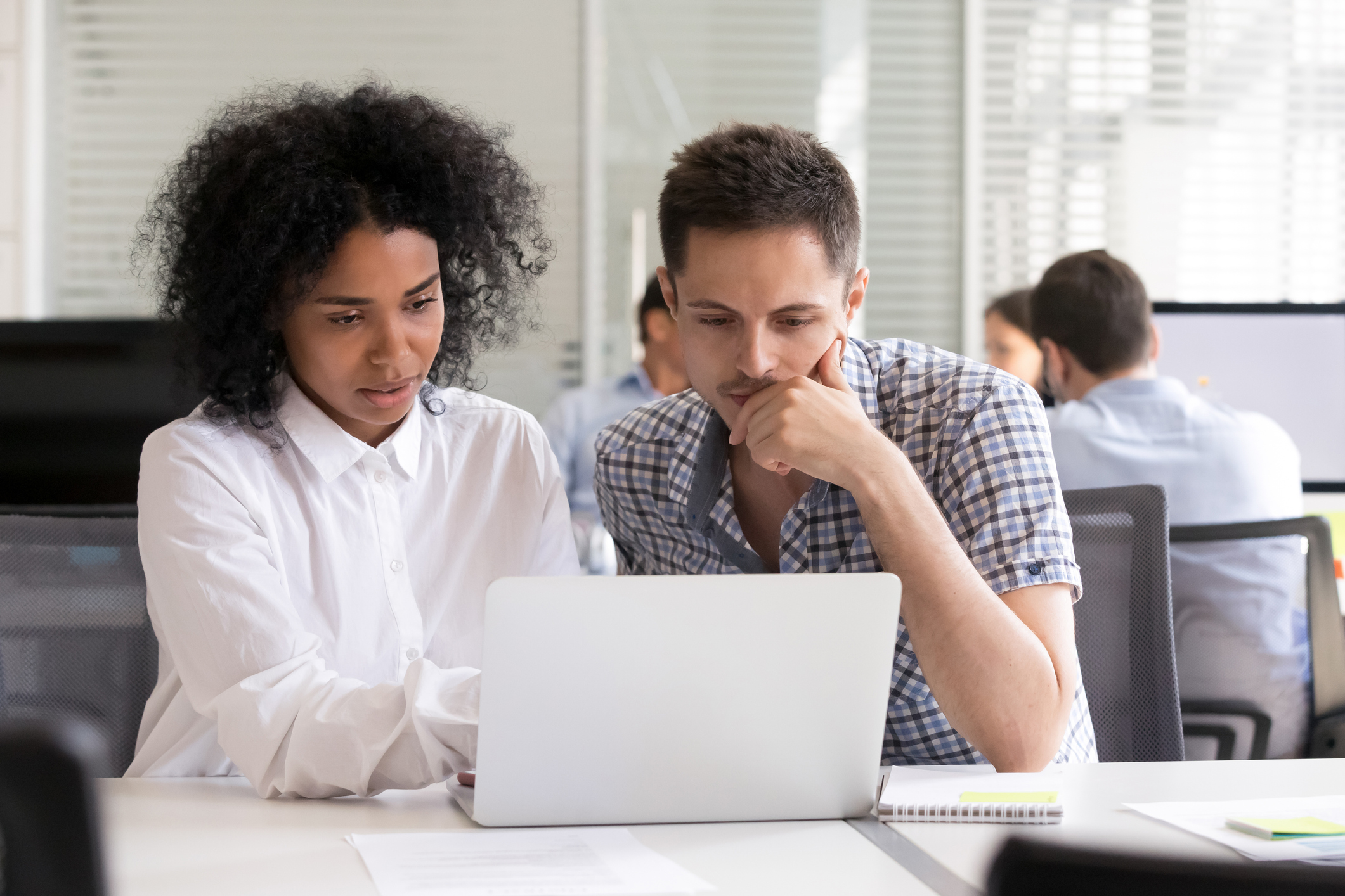 Serious diverse office colleagues discussing online project results Collaborative is Diverse